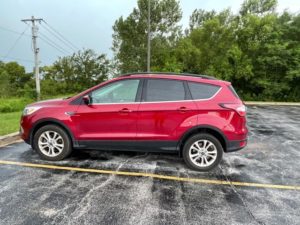 red 2018 ford escape in a parking lot