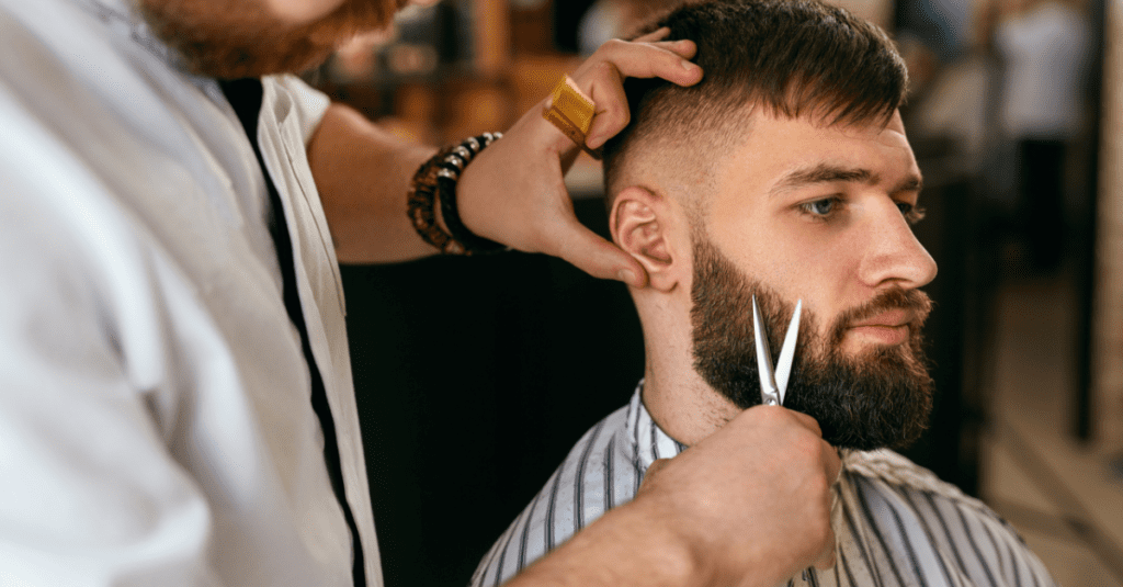 barber working on a nice kept beard
