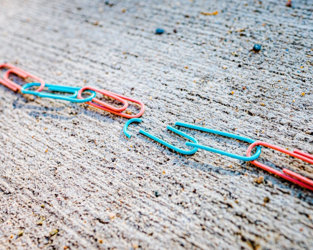 colorful paperclips in a chain, chain is broken