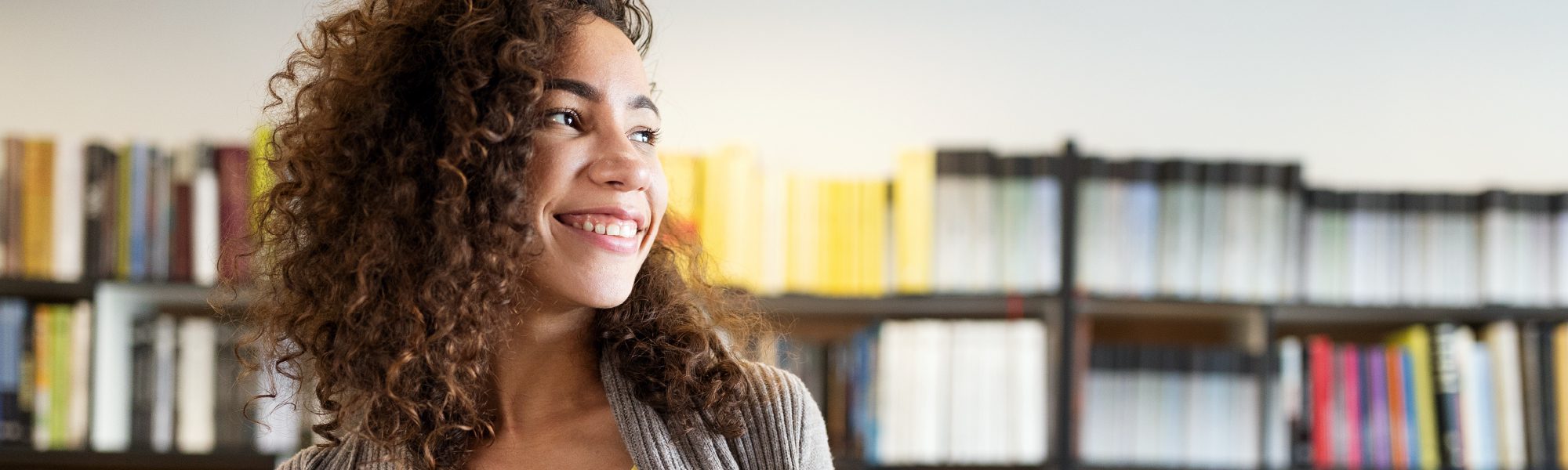 girl in library smiling
