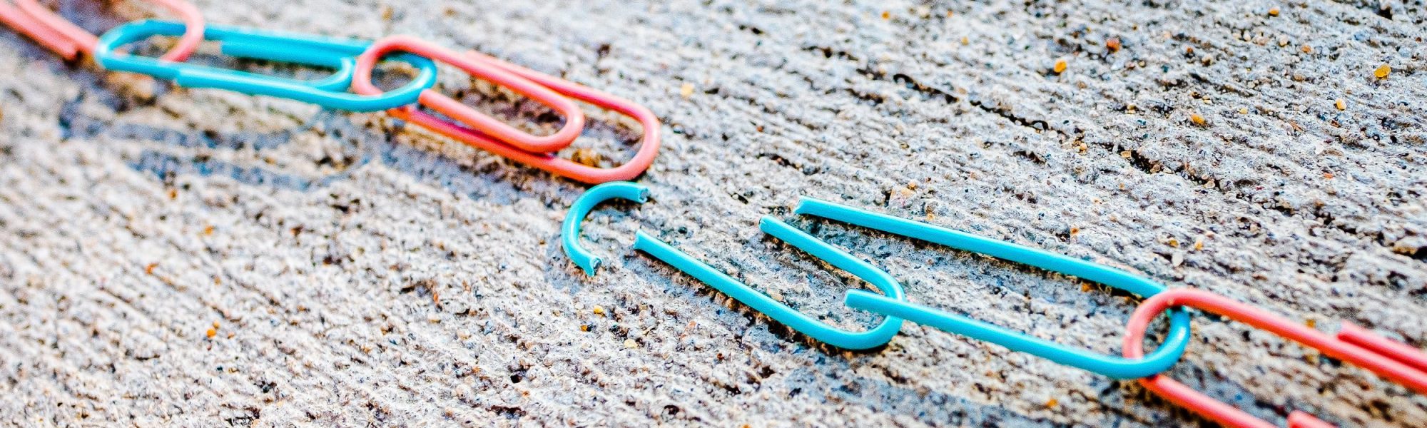 colorful paperclips in a chain, chain is broken